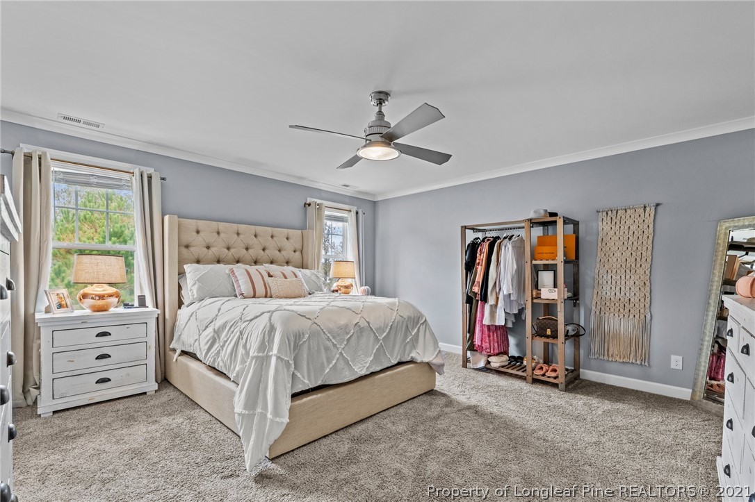 171 Apache Trail Sanford, NC 27332 - Photo 24 of 38 a bed room with a bed and a ceiling fan