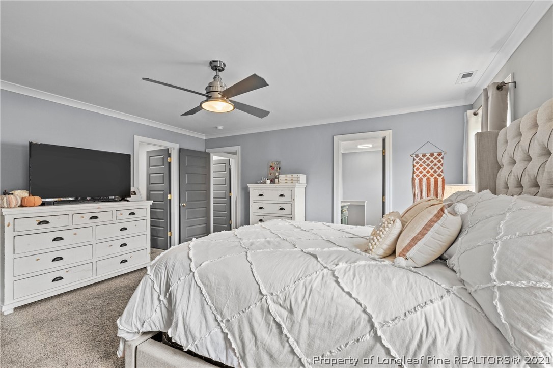 171 Apache Trail Sanford, NC 27332 - Photo 25 of 38 a bedroom with a bed and a flat screen tv