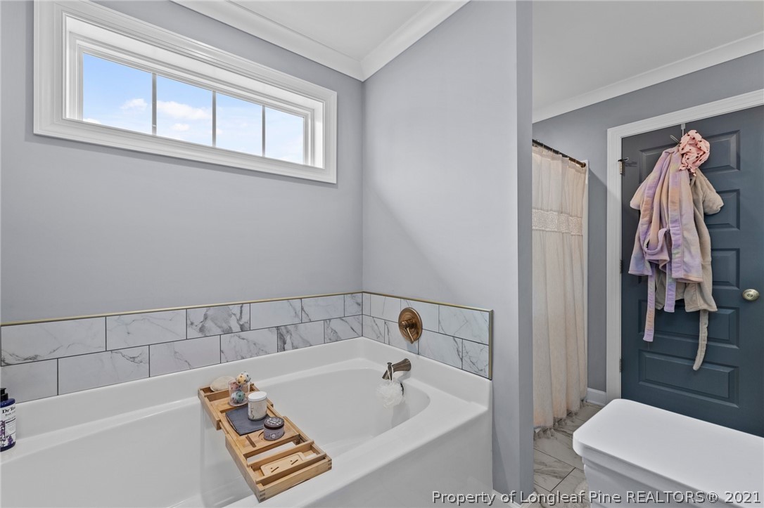 171 Apache Trail Sanford, NC 27332 - Photo 27 of 38 a bathroom with a bathtub and a toilet