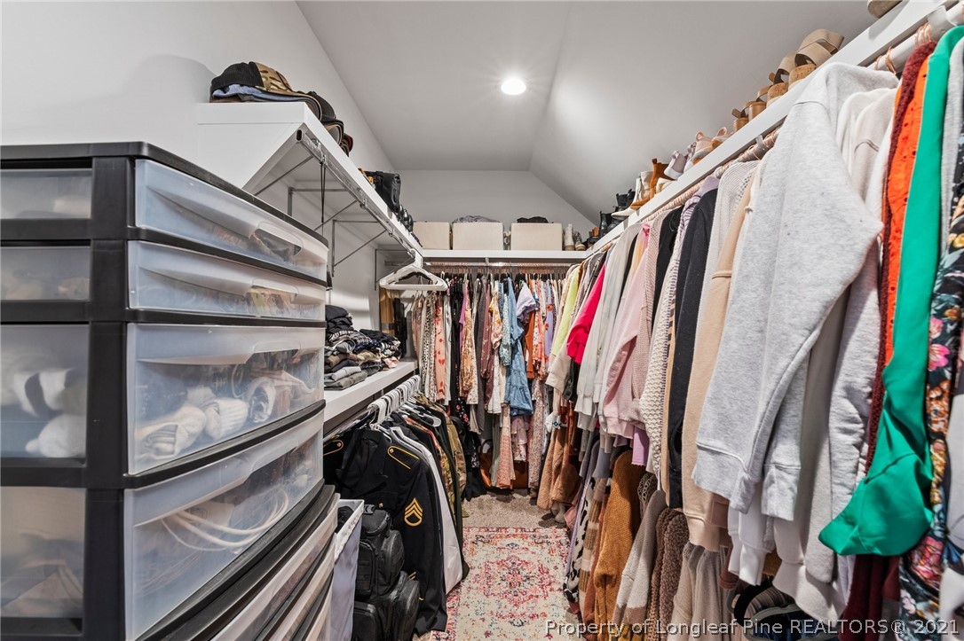 171 Apache Trail Sanford, NC 27332 - Photo 29 of 38 a view of walk in closet with clothes and shoes