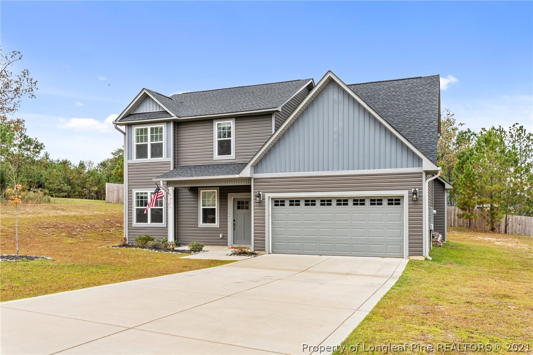 171 Apache Trail Sanford, NC 27332 - Photo 3 of 38 a front view of a house with a yard and garage