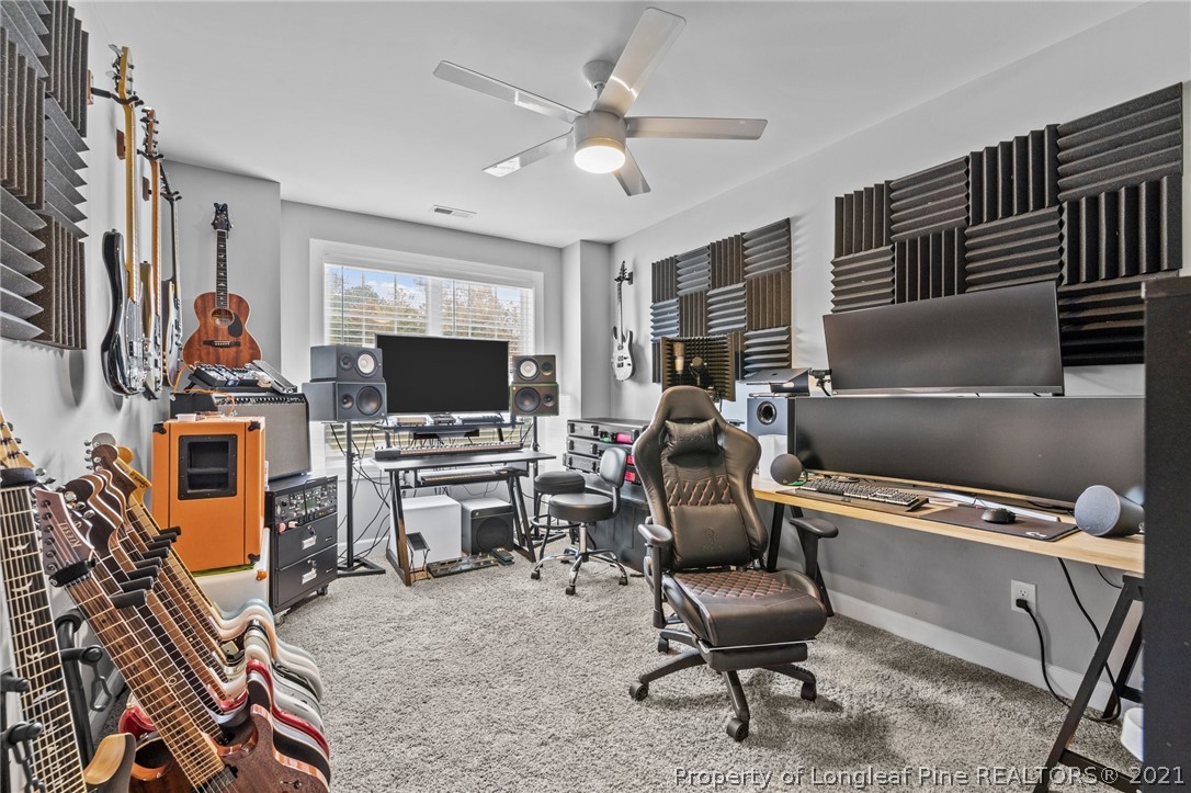 171 Apache Trail Sanford, NC 27332 - Photo 34 of 38 a work room with furniture a flat screen tv and a window