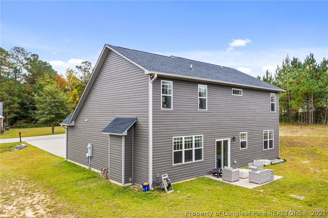 171 Apache Trail Sanford, NC 27332 - Photo 35 of 38 a backyard of a house with yard table and chairs