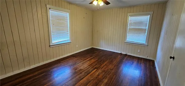 a view of a house with wooden fence and floor