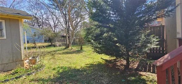 a view of a yard with yellow house