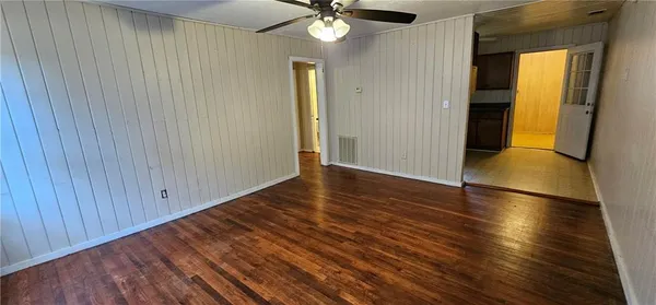 a view of empty room with wooden floor
