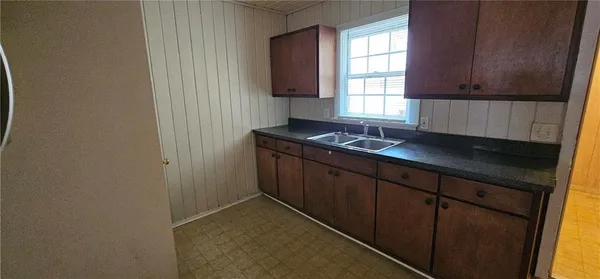 a kitchen with granite countertop cabinets and window