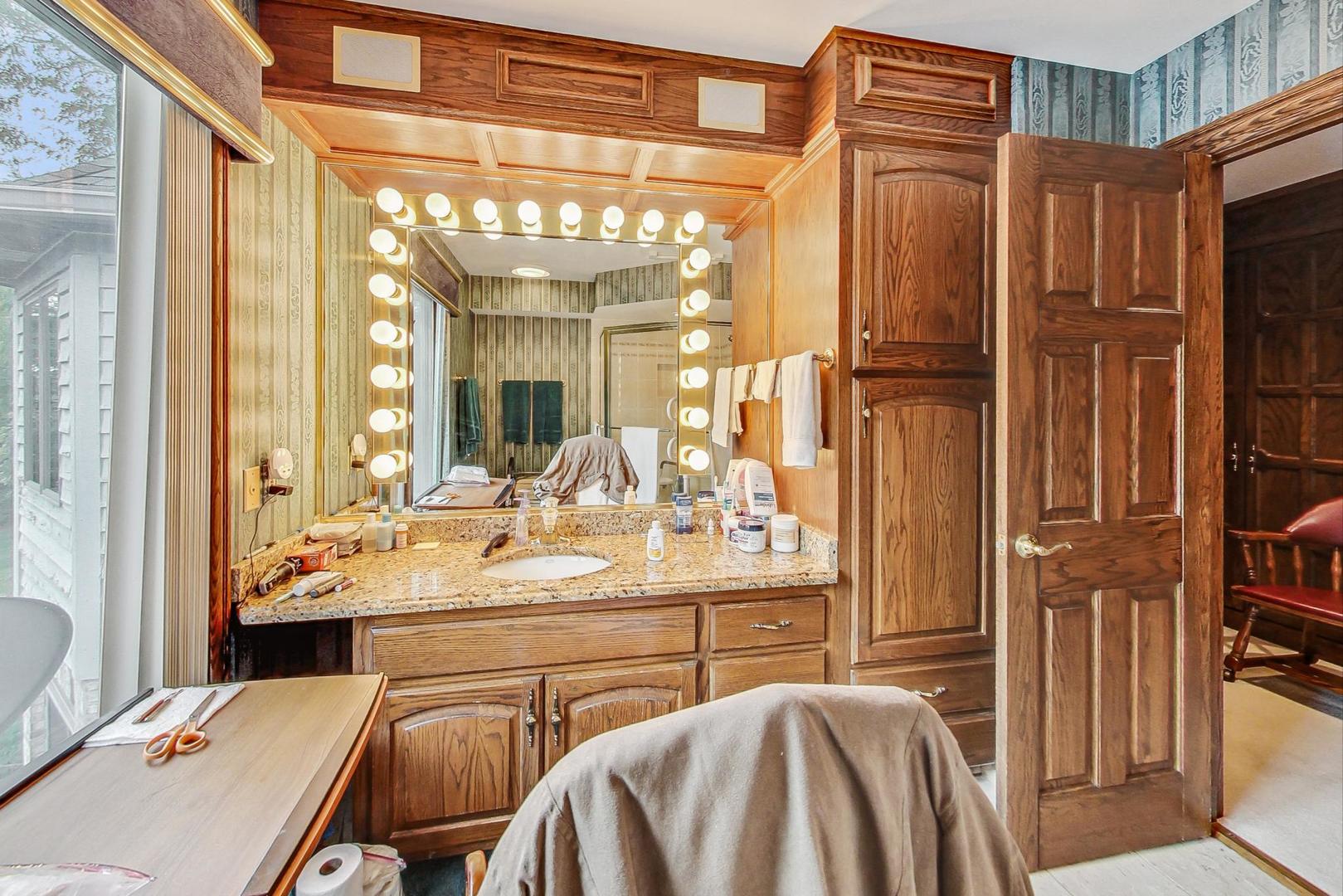 3S201 South Raddant Road Batavia, IL 60510 - Photo 27 of 58 a en suite bathroom with a sink a large mirror and a bathtub