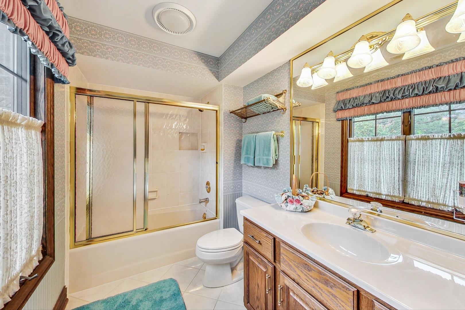 3S201 South Raddant Road Batavia, IL 60510 - Photo 31 of 58 a bathroom with a sink a toilet and shower