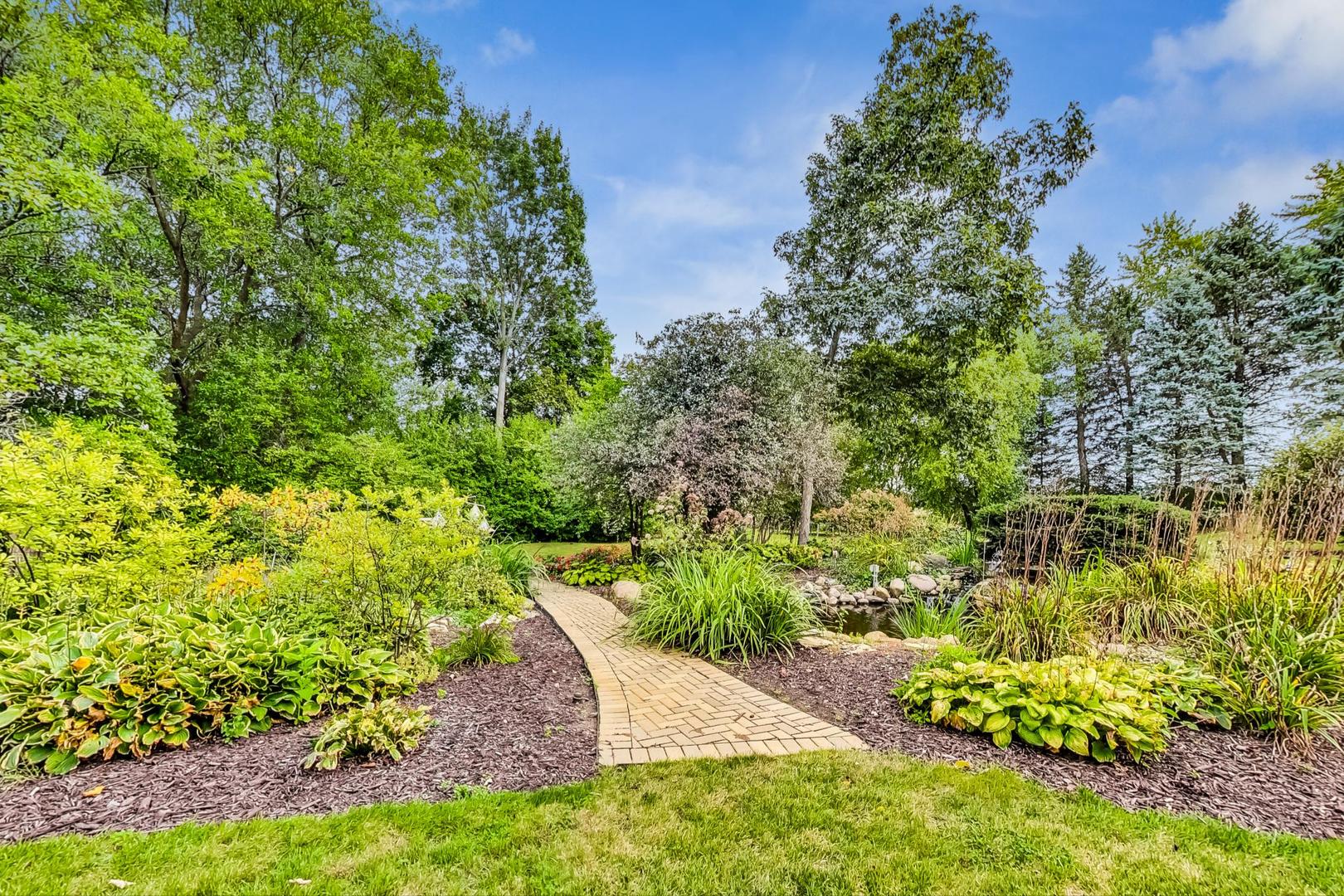3S201 South Raddant Road Batavia, IL 60510 - Photo 53 of 58 a view of a garden with plants and large trees