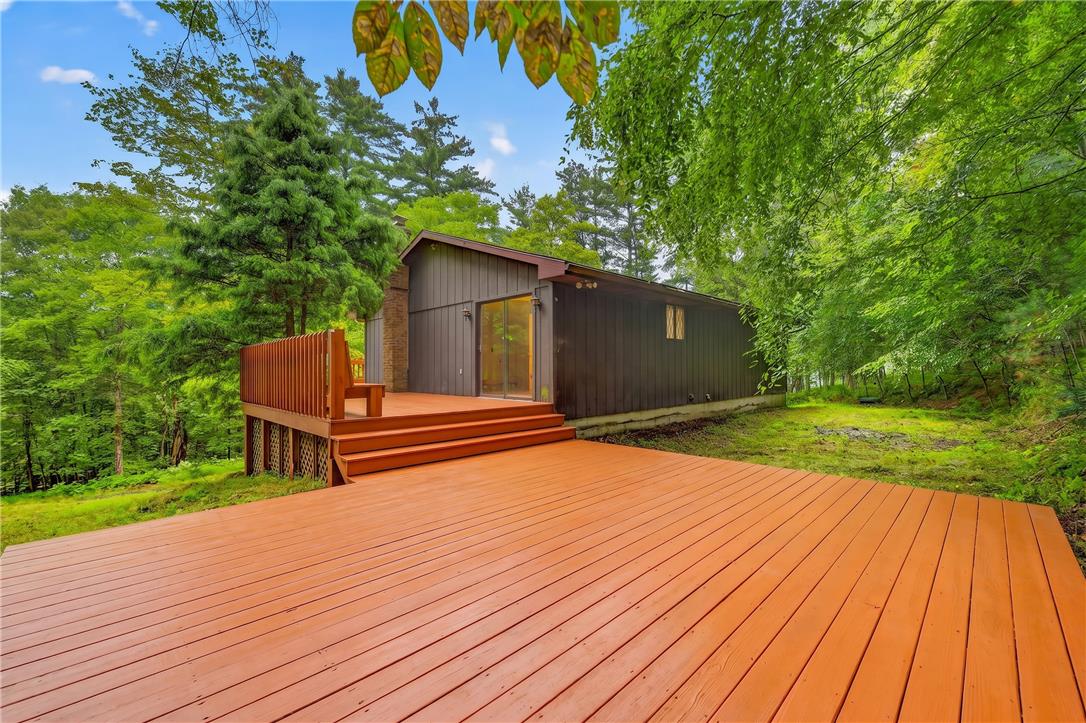 1570 Astolat Road Effort, PA 18330 - Photo 46 of 48 A spacious wooden deck connects the home directly to the surrounding wooded landscape.