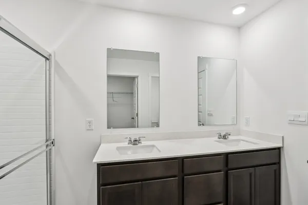 a bathroom with a sink double vanity and a mirror