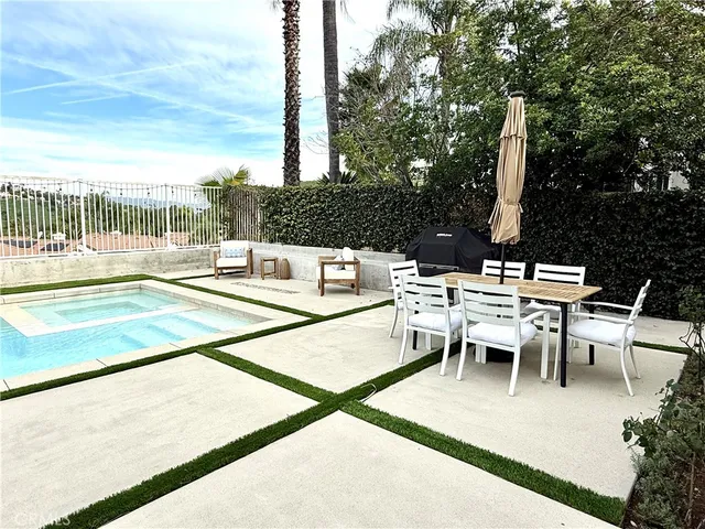 a view of a patio with a table and chairs