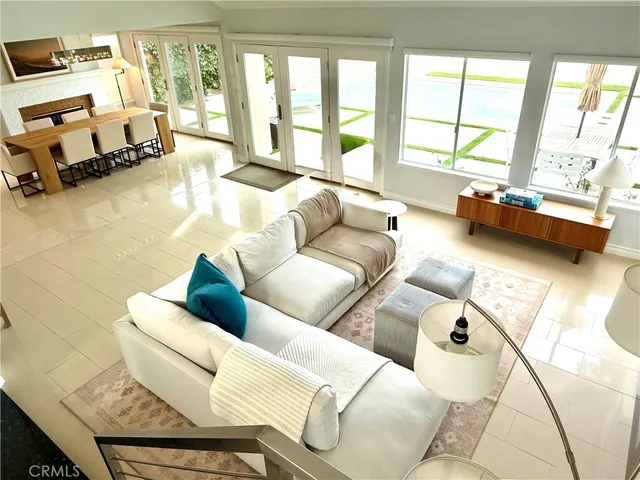 a living room with furniture and floor to ceiling windows
