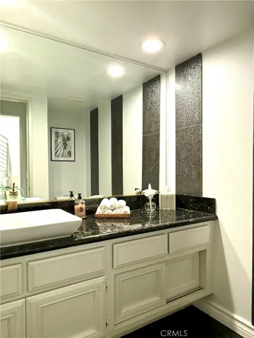 a bathroom with double sink and a mirror