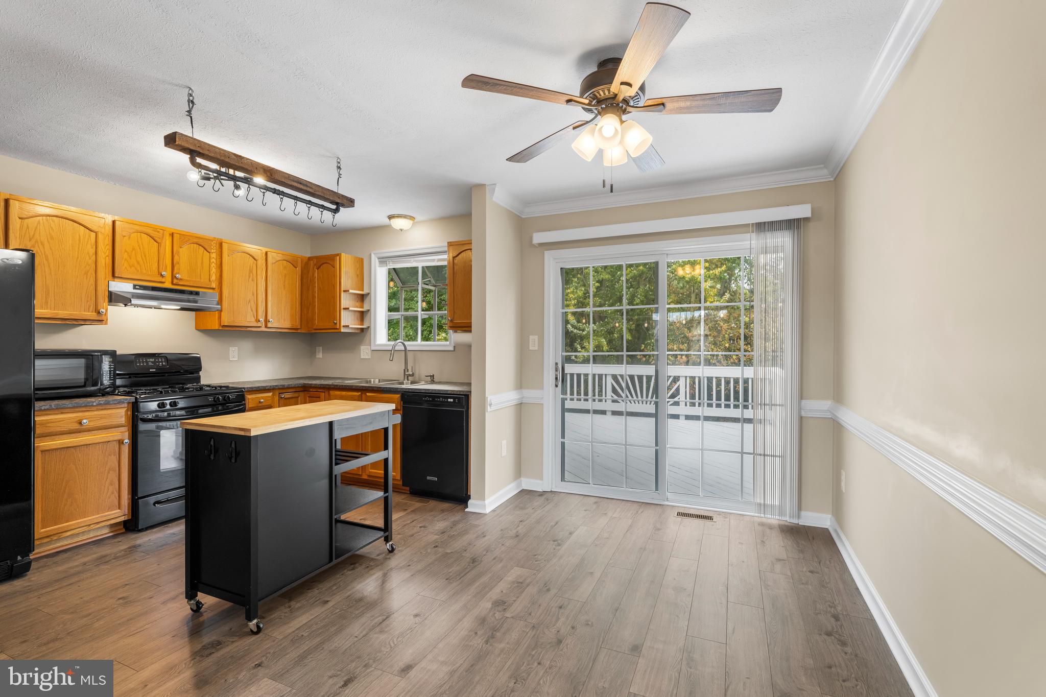 3836 Dakota Road Hampstead, MD 21074 - Photo 12 of 47 a kitchen with stainless steel appliances granite countertop a stove and a refrigerator