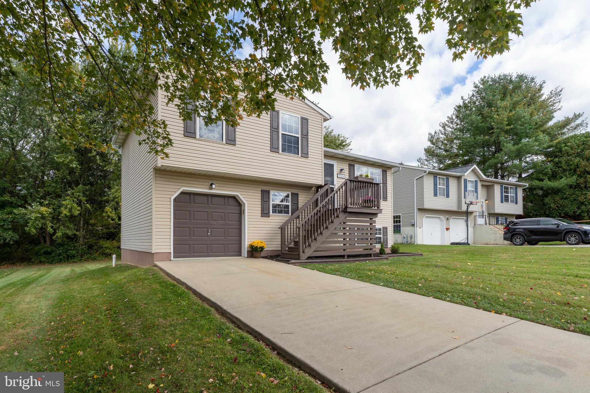 3836 Dakota Road Hampstead, MD 21074 - Photo 2 of 47 a front view of a house with a garden and yard