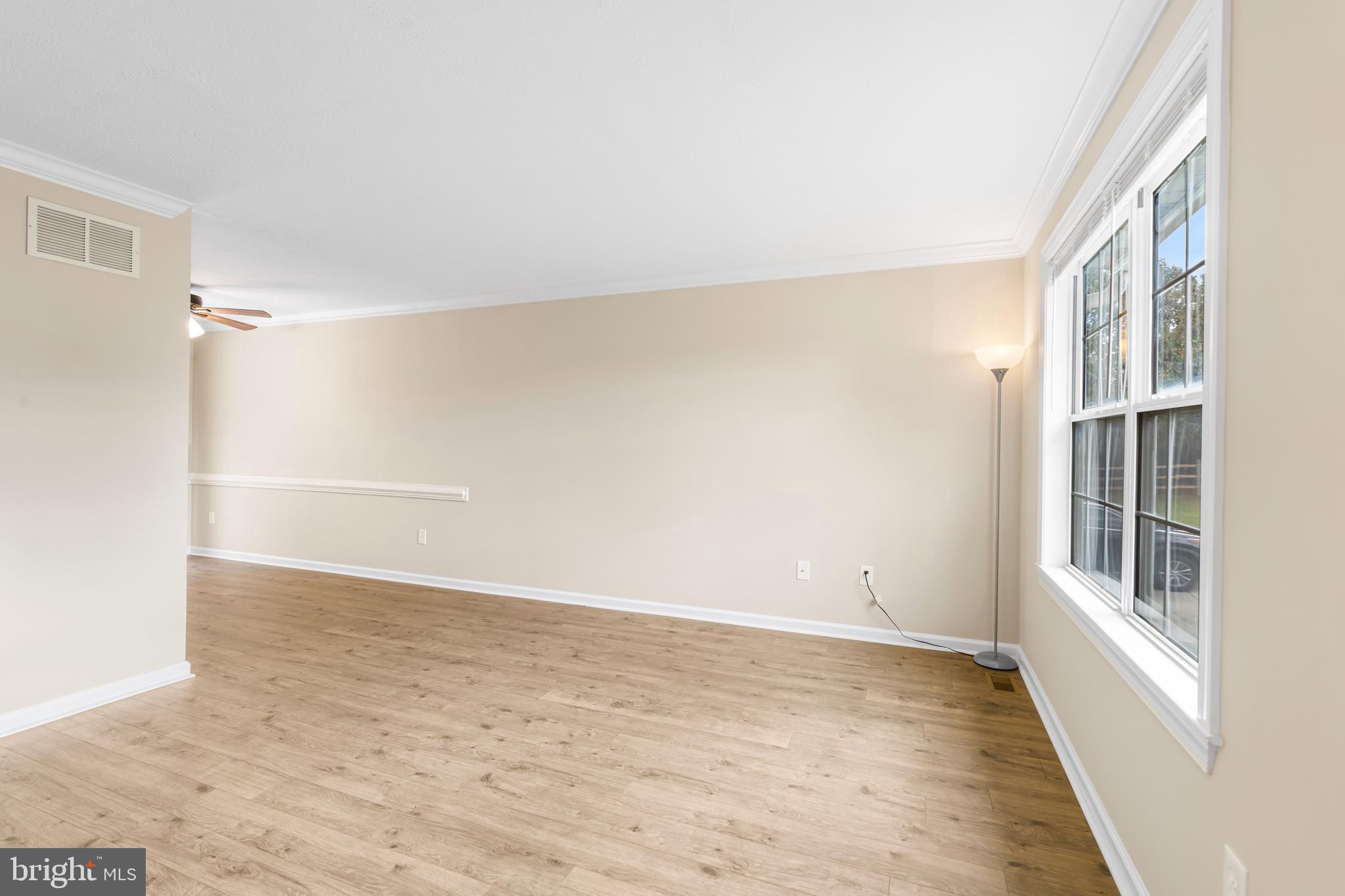 3836 Dakota Road Hampstead, MD 21074 - Photo 9 of 47 a view of an empty room with wooden floor and a window