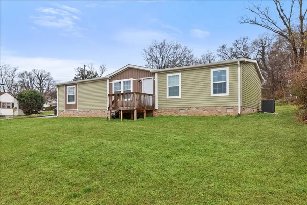a view of a house with a backyard