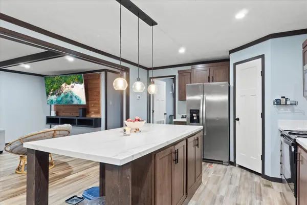 a kitchen with a table chairs refrigerator and cabinets
