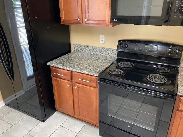 a stove top oven sitting inside of a kitchen