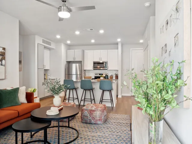 a living room with furniture potted plant and a chandelier
