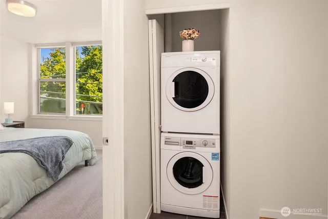 a view of a bedroom with a washer and dryer