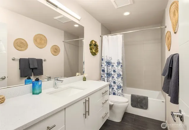 a bathroom with a sink a toilet and a mirror