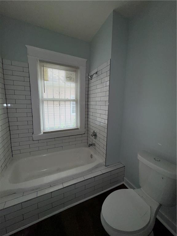 1462 Lucile Avenue Southwest Atlanta, GA 30310 - Photo 11 of 22 a bathroom with a toilet bathtub and window