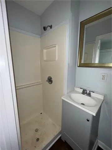 a bathroom with a sink and mirror with toilet