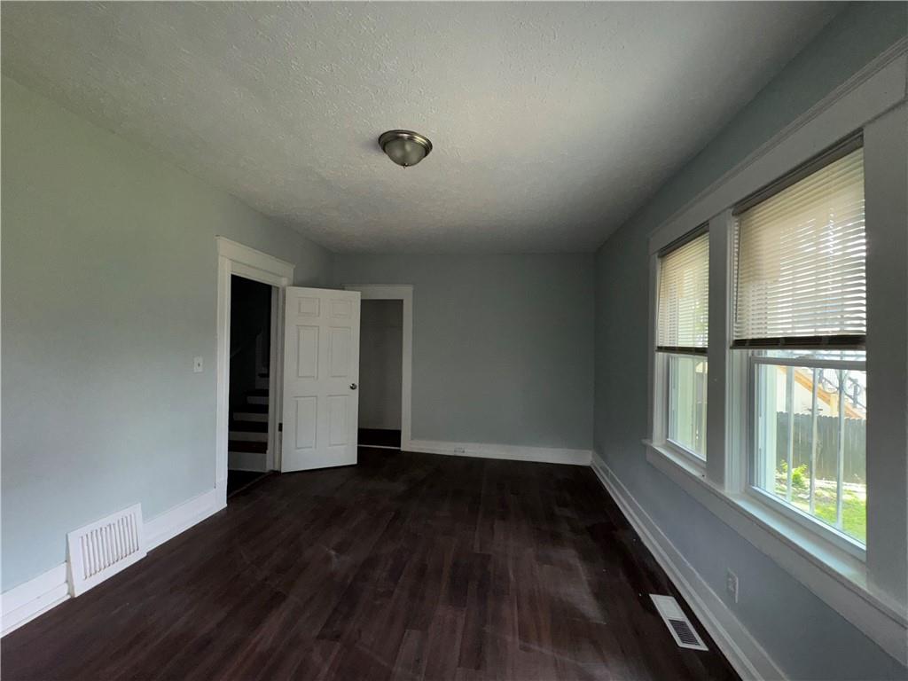1462 Lucile Avenue Southwest Atlanta, GA 30310 - Photo 14 of 22 an empty room with wooden floor and a window