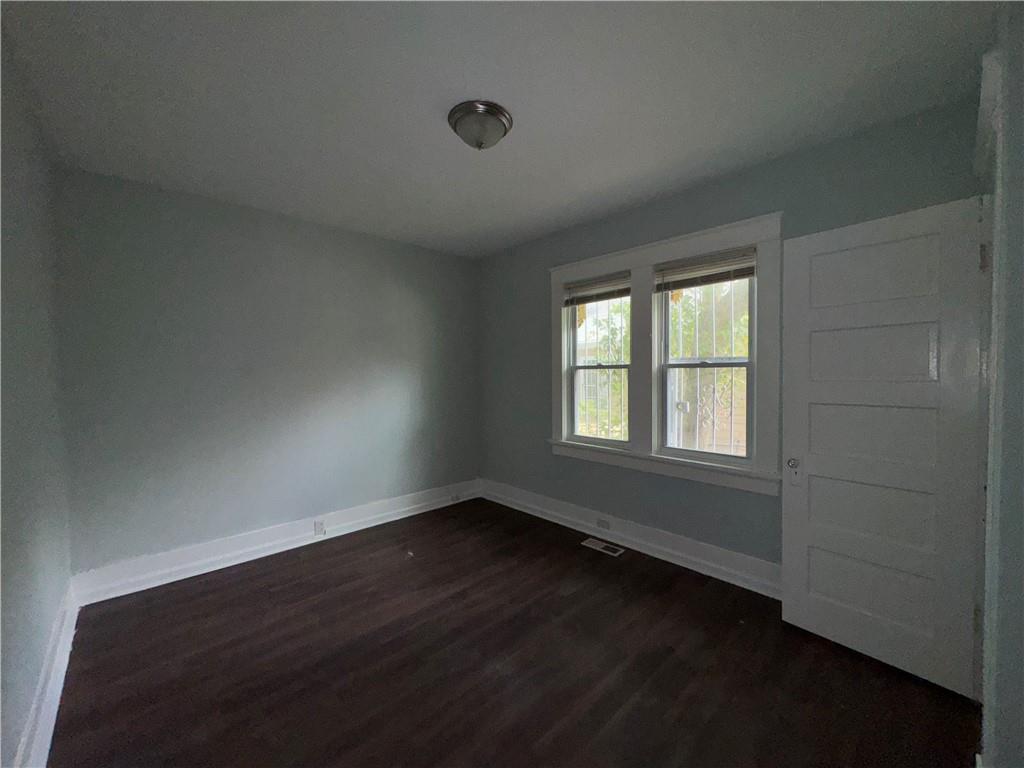 1462 Lucile Avenue Southwest Atlanta, GA 30310 - Photo 15 of 22 an empty room with wooden floor and windows