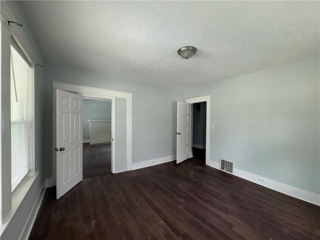 1462 Lucile Avenue Southwest Atlanta, GA 30310 - Photo 3 of 22 an empty room with wooden floor and closet