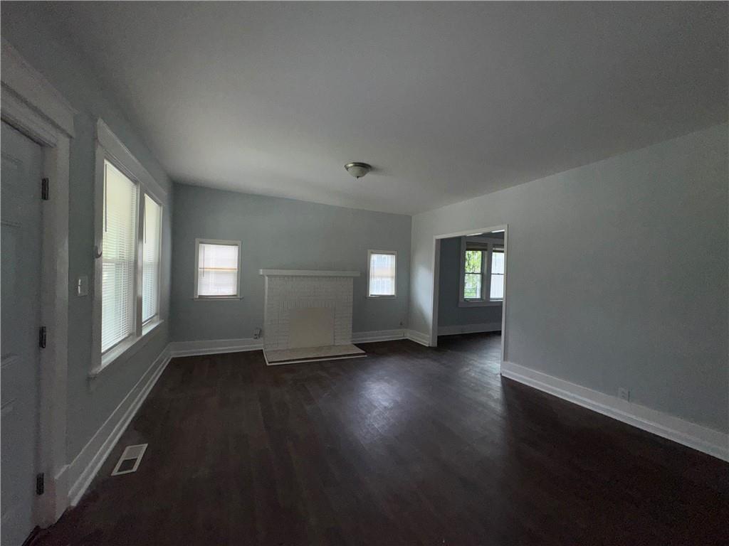 1462 Lucile Avenue Southwest Atlanta, GA 30310 - Photo 4 of 22 an empty room with wooden floor and windows