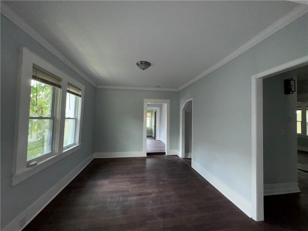 1462 Lucile Avenue Southwest Atlanta, GA 30310 - Photo 5 of 22 a view of an empty room with wooden floor and a window
