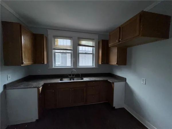 a kitchen with stainless steel appliances a sink stove and cabinets