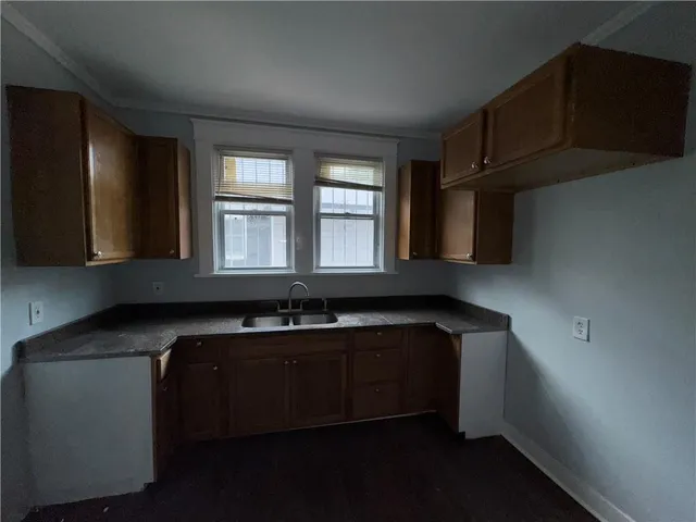 a kitchen with stainless steel appliances a sink stove and cabinets