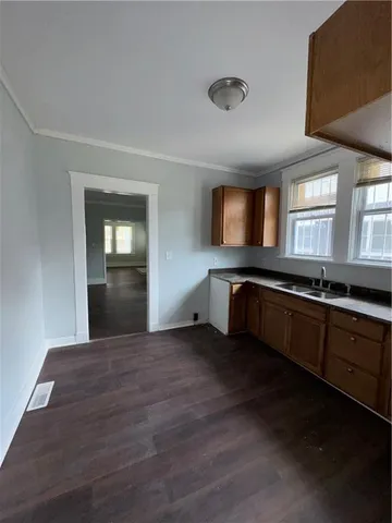 a large hall with wooden floor and front door