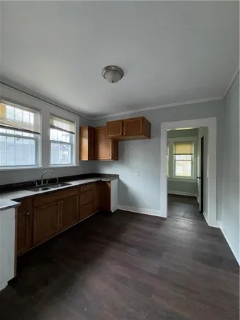 a large kitchen with stainless steel appliances a large counter top