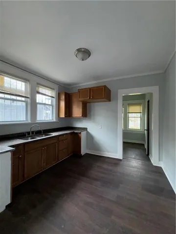 a large kitchen with stainless steel appliances a large counter top