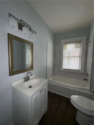a bathroom with a sink a toilet and tub