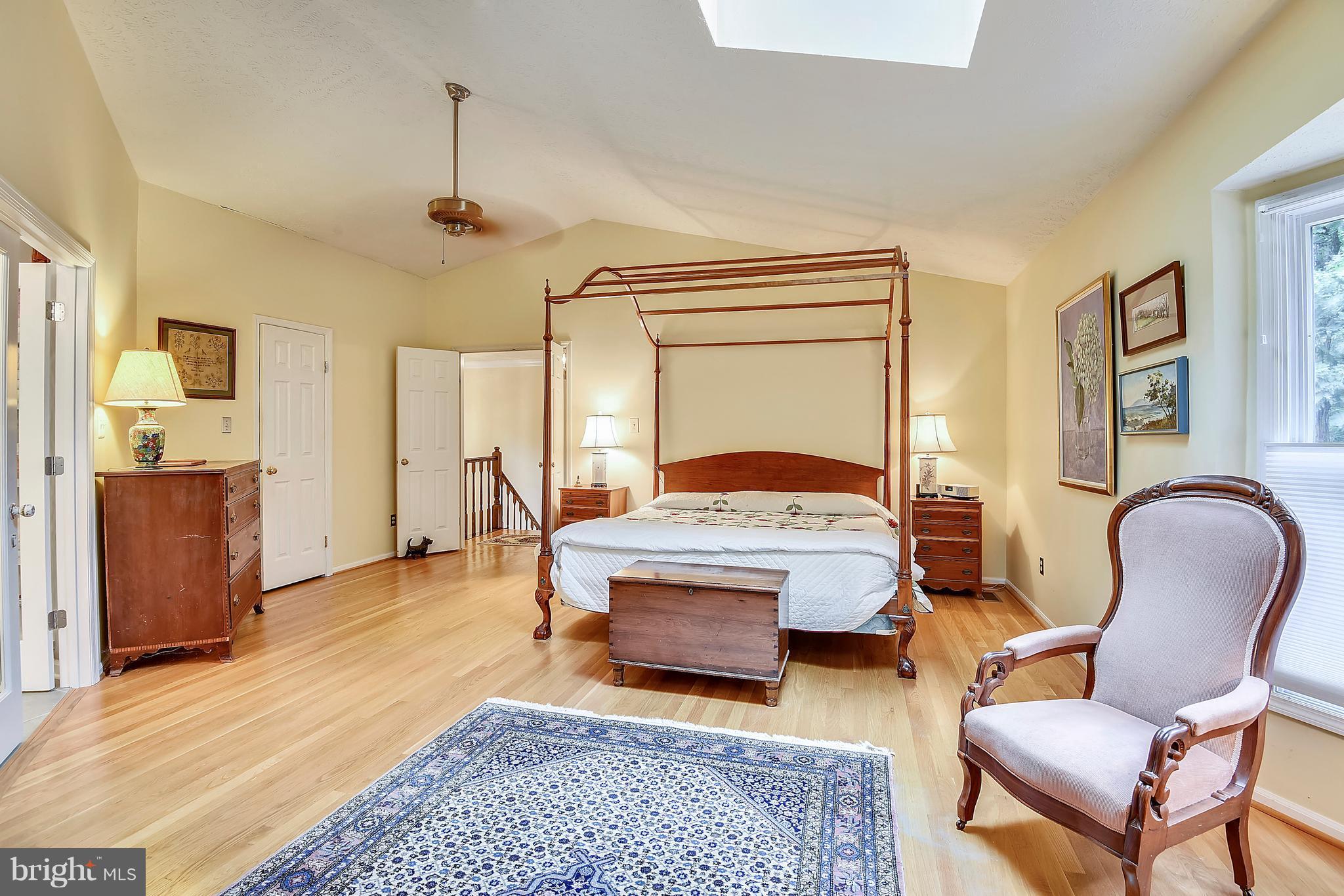 11692 Bennington Woods Road Reston, VA 20194 - Photo 14 of 29 a bedroom with a bed and wooden floor