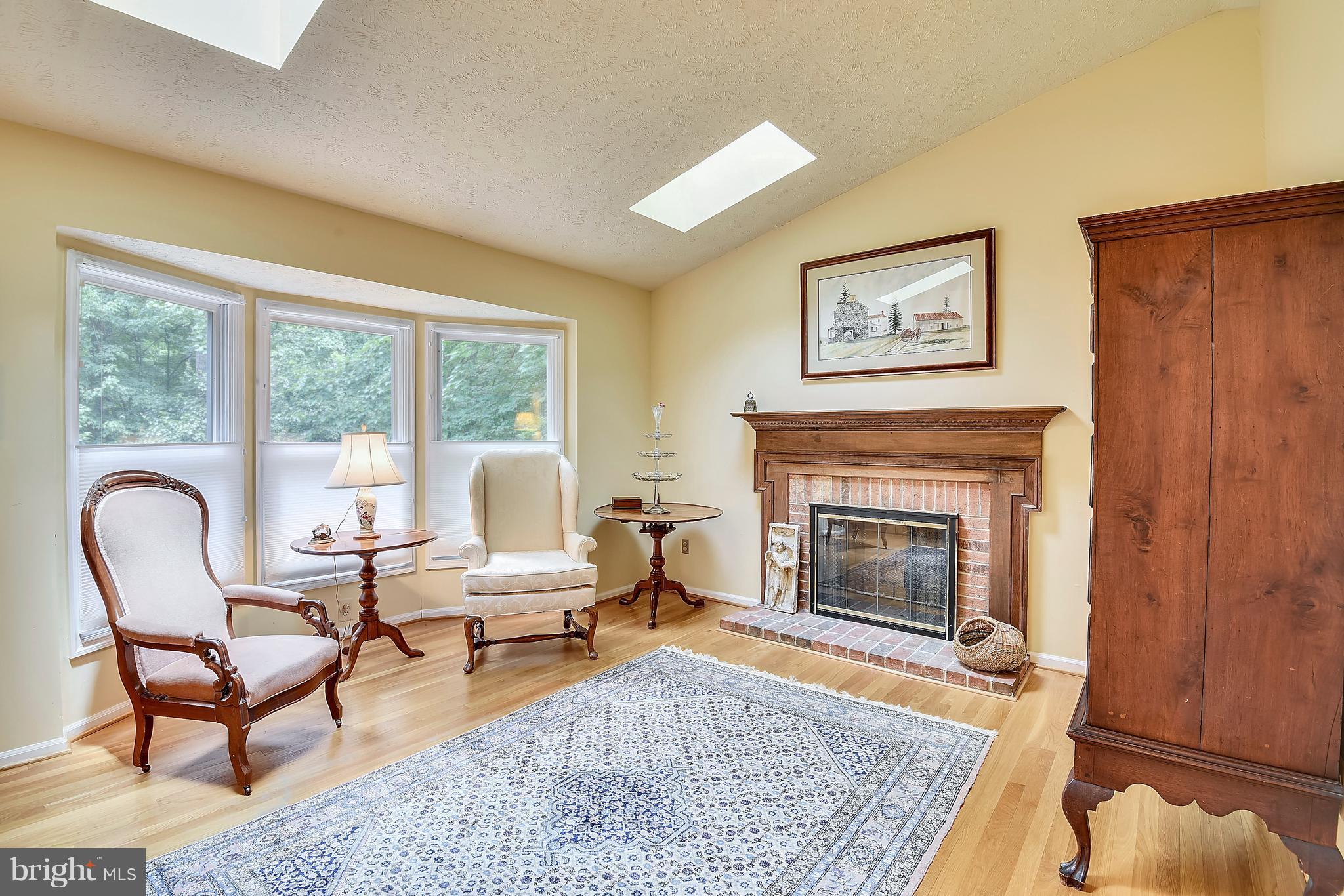 11692 Bennington Woods Road Reston, VA 20194 - Photo 15 of 29 a living room with furniture rug and a fireplace
