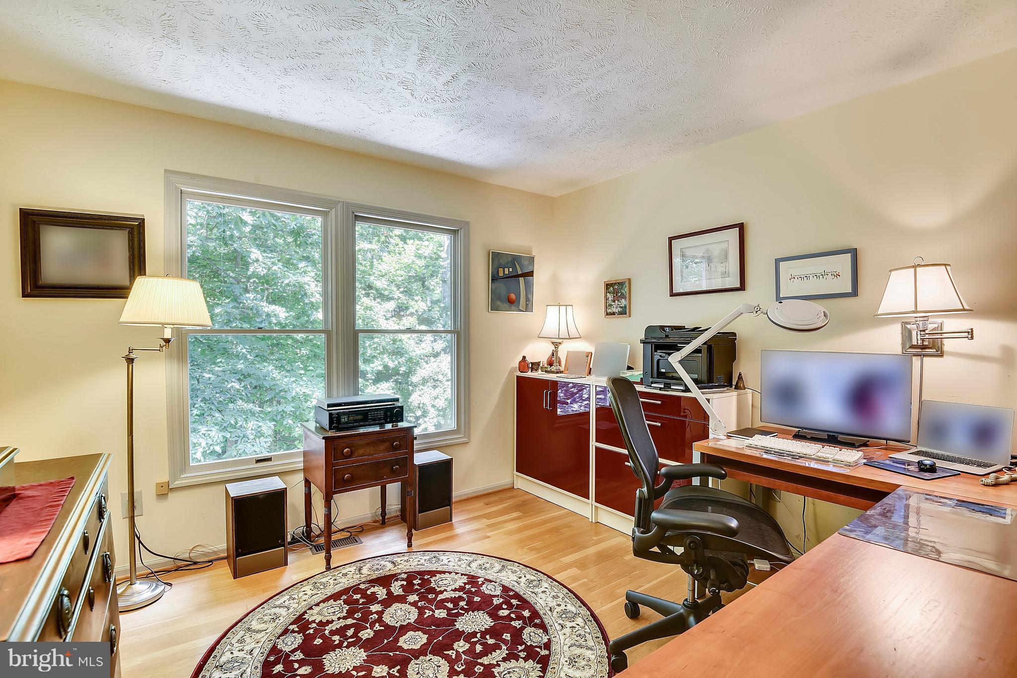 11692 Bennington Woods Road Reston, VA 20194 - Photo 21 of 29 a bedroom with a bed and wooden floor