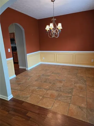 a kitchen with granite countertop wooden floors and wide window