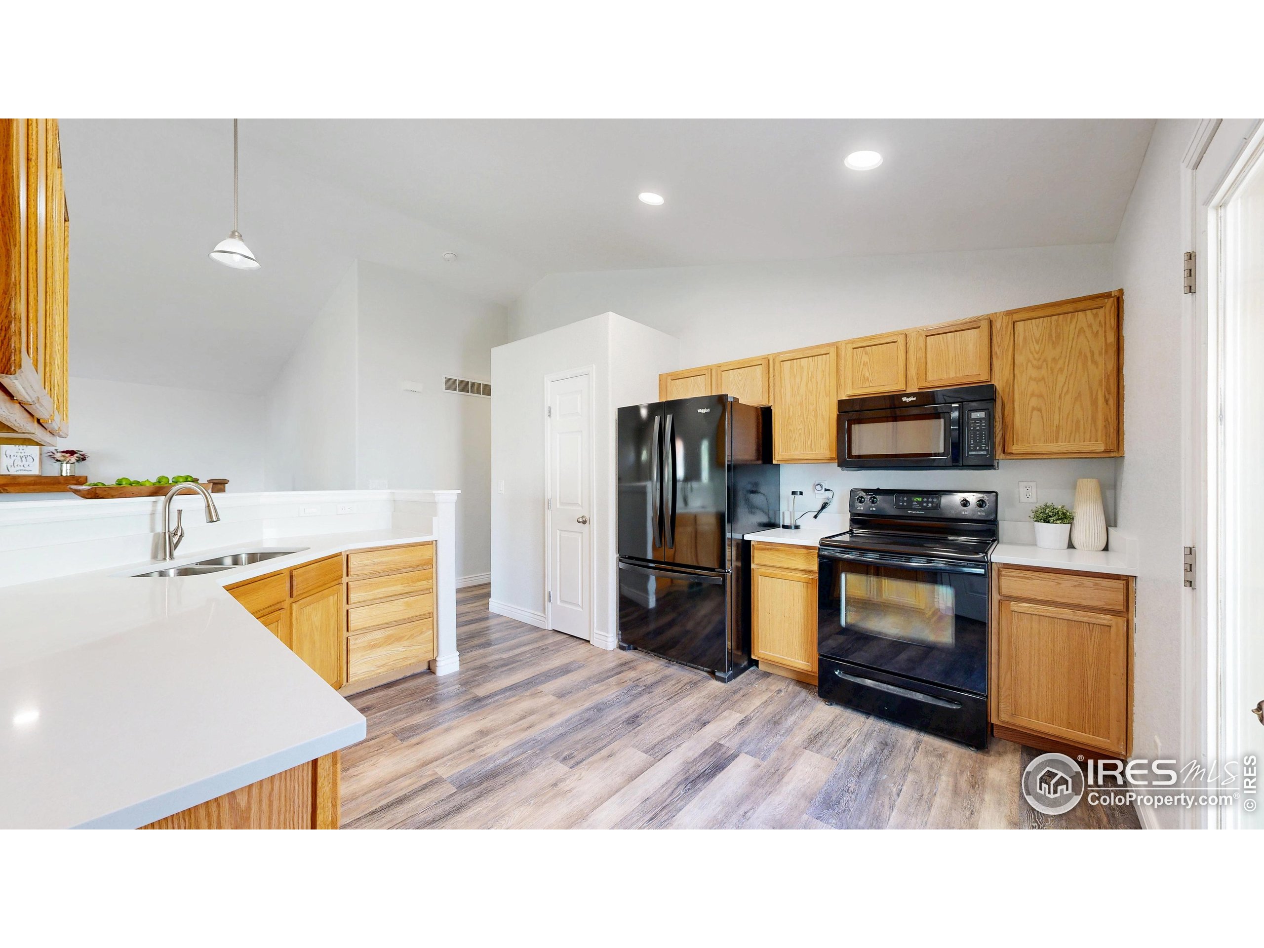 315 Coal Ridge Drive Frederick, CO 80530 - Photo 3 of 25 a kitchen with stainless steel appliances kitchen island granite countertop a refrigerator and a stove top oven