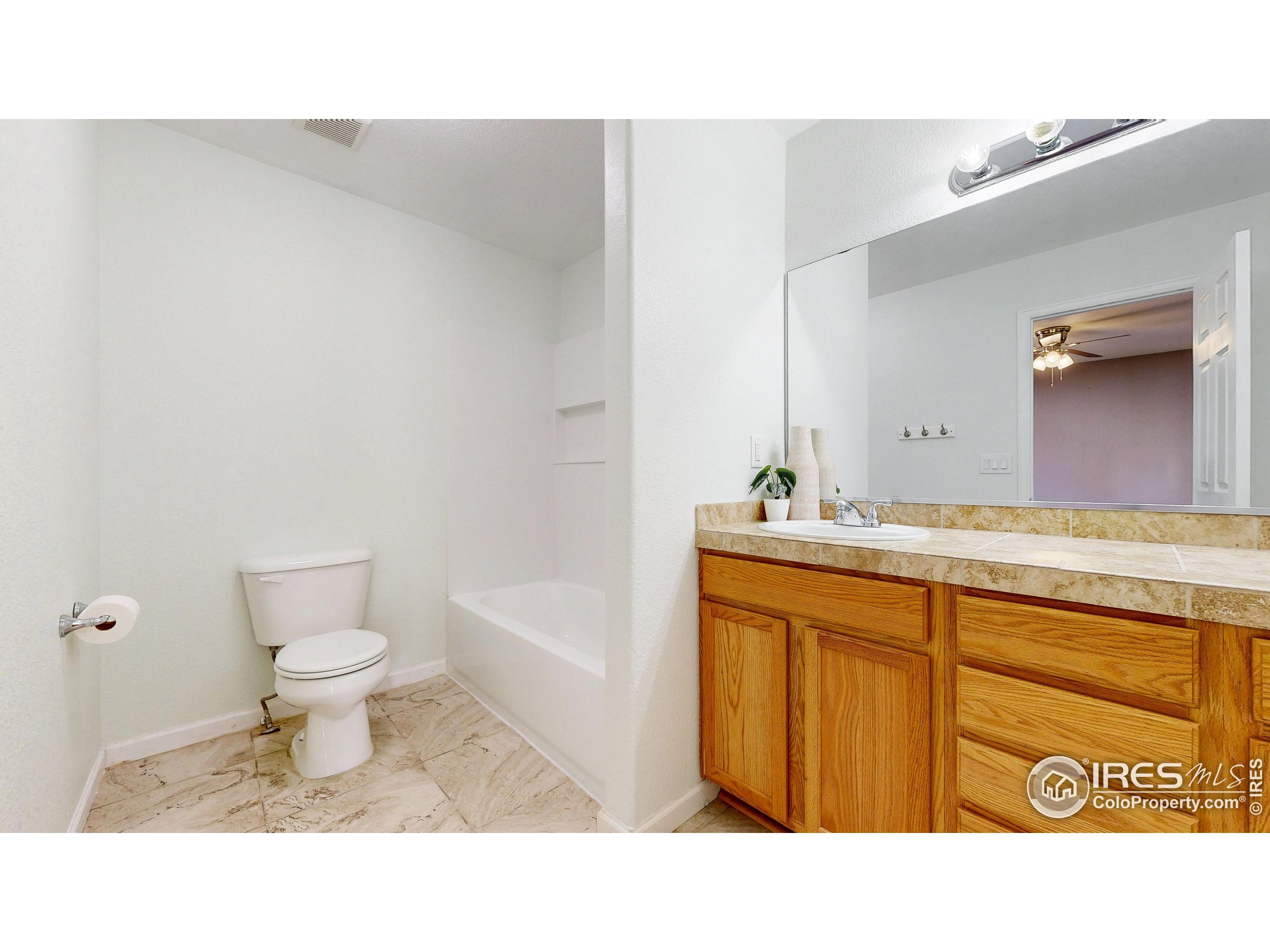315 Coal Ridge Drive Frederick, CO 80530 - Photo 7 of 25 a bathroom with a sink a toilet and a mirror