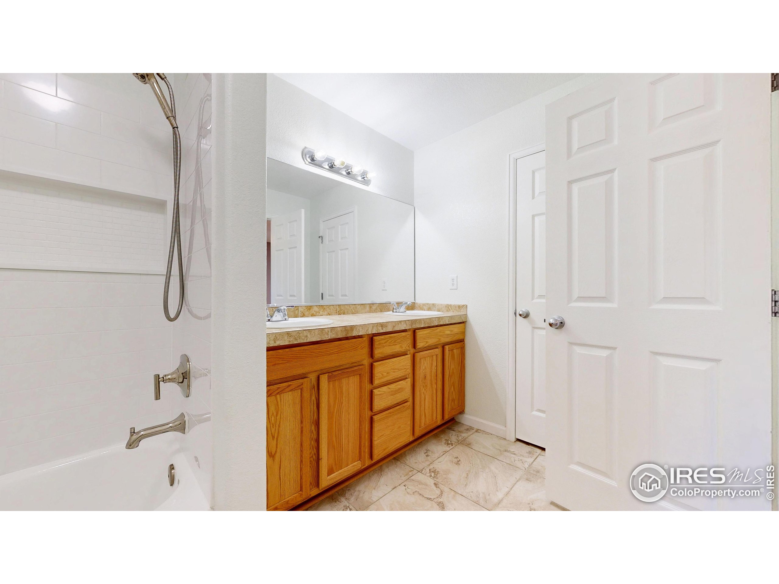 315 Coal Ridge Drive Frederick, CO 80530 - Photo 8 of 25 a bathroom with a sink a mirror and a bathtub
