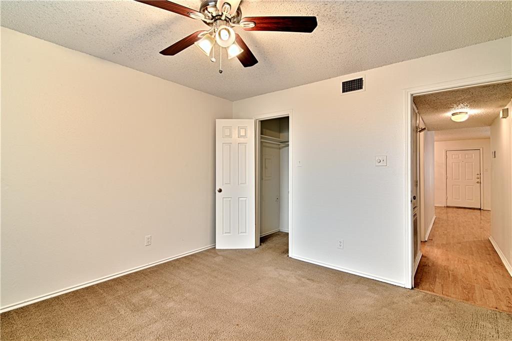 2401 Leon Street, Unit 104 Austin, TX 78705 - Photo 12 of 21 an empty room with closet and a chandelier fan