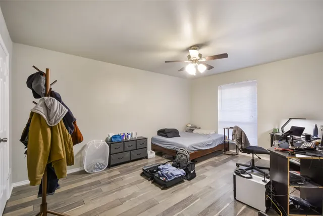 a living room with furniture a wooden floor and a chandelier